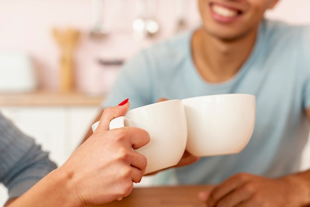 Close-up happy couple with coffee cups