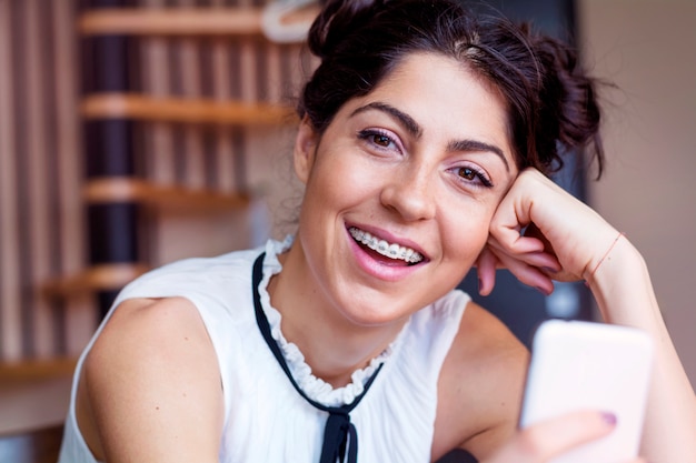 Close-up of happy girl with her mobile