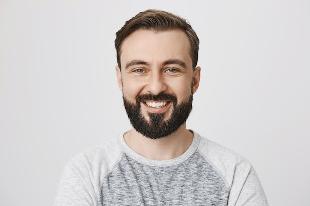 Close-up of happy laughing bearded man smiling