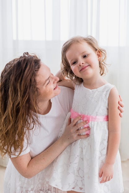 Close-up of happy mother and daughter at home