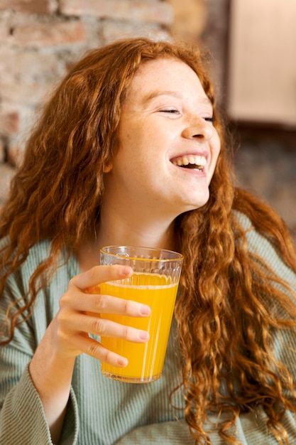 Close up happy woman holding glass