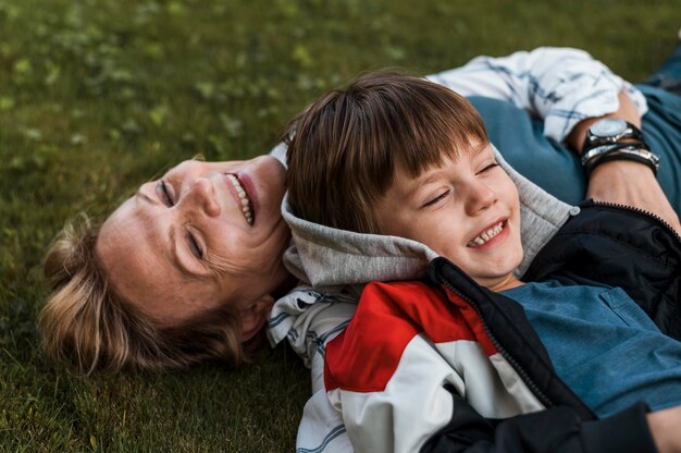 Close-up happy woman and kid on grass