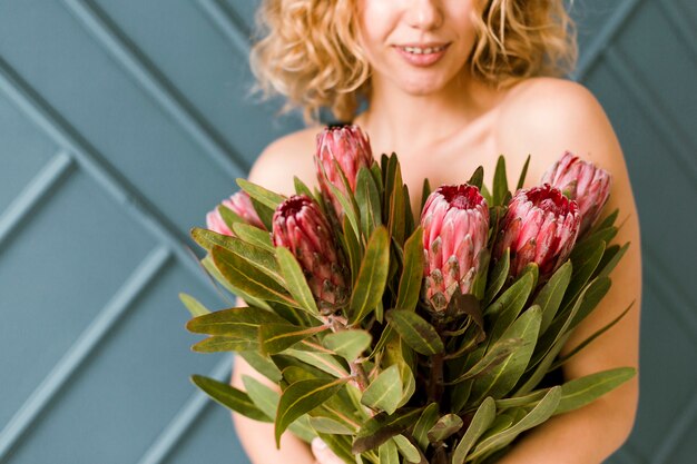 Close-up happy woman with bouquet indoors