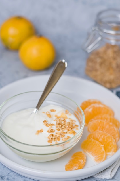 Close-up healthy breakfast with yogurt and orange