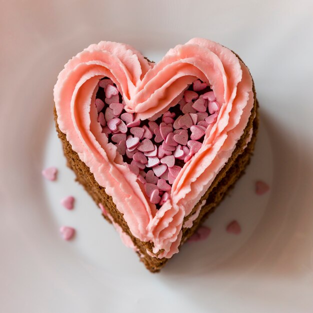 Close-up of heart-shaped cake slice with frosting