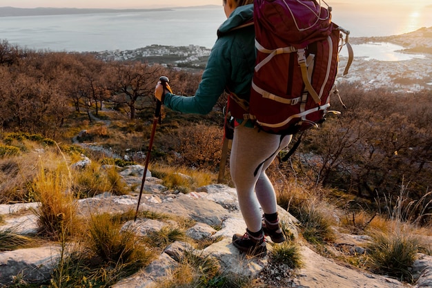 Free photo close up hiker carrying backpack