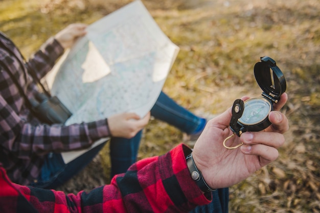 Free Photo close-up of hiker with a compass in his hand