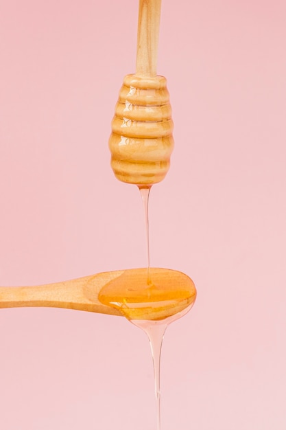 Close-up honey pouring on a spoon