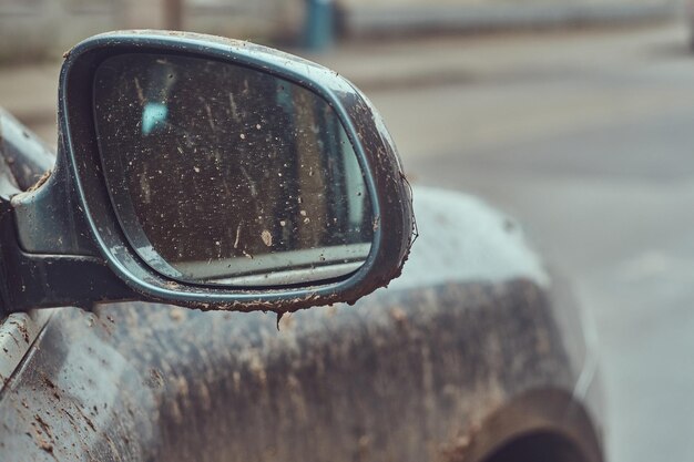 Close-up image of a dirty car after a trip around the countryside