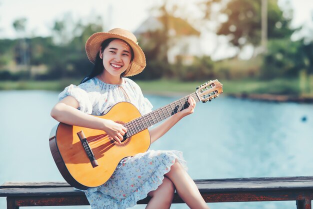 Close up images of woman's hands playing acoustic guitar