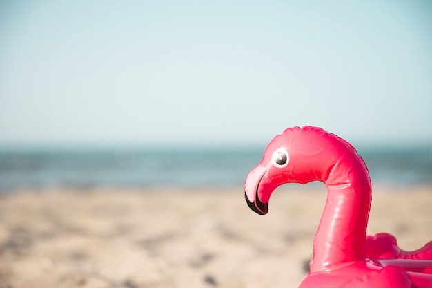 Free photo close up inflatble flamingo swim ring on beach