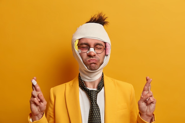 Free Photo close up on injured man with dark bruise under eyes and brain concussion, wears bandage