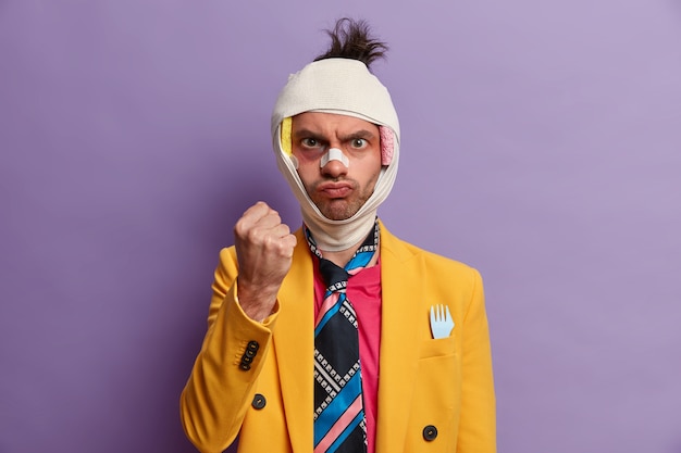 Free photo close up on injured man with dark bruise under eyes and brain concussion, wears bandage