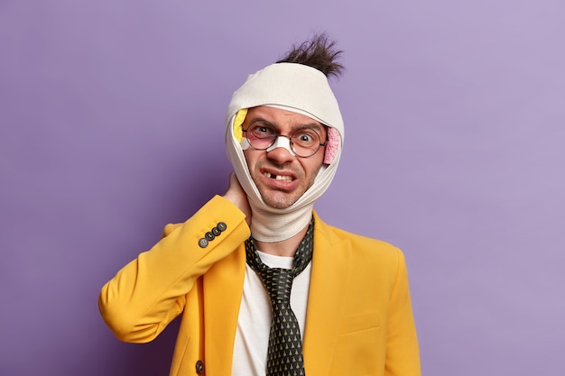 Free Photo close up on injured man with dark bruise under eyes and brain concussion, wears bandage