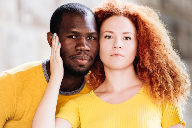 Close-up of interracial couple facing the camera