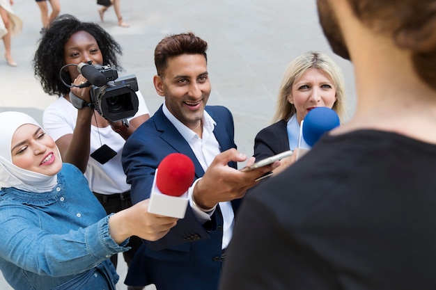 Close up on interviewee with microphone taking statements