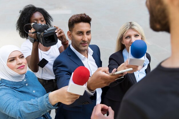 Close up on interviewee with microphone taking statements