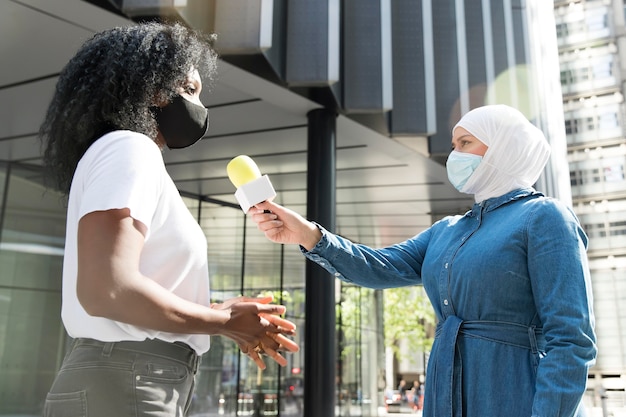 Close up on interviewee with microphone taking statements