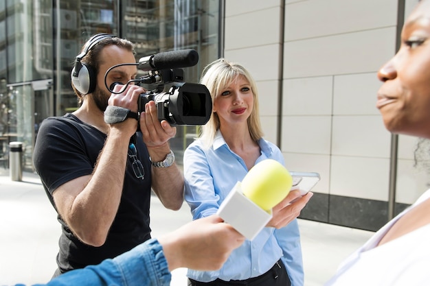 Close up on interviewee with microphone taking statements