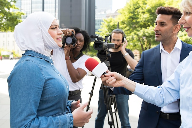 Close up on interviewee with microphone taking statements