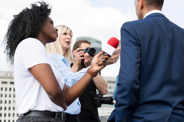 Close up on interviewee with microphone taking statements