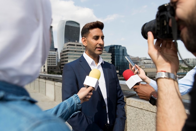 Close up on interviewee with microphone taking statements