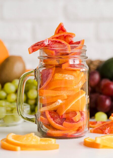 Close-up jar with grapefruit slices on the table