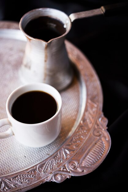 Close-up kettle and coffee on a silver plate