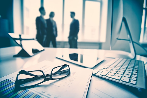 Close-up of keyboard and glasses with executives background