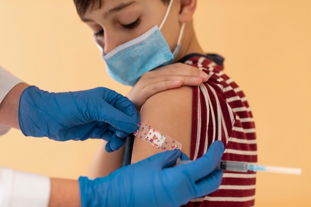 Free Photo close up kid after getting vaccine