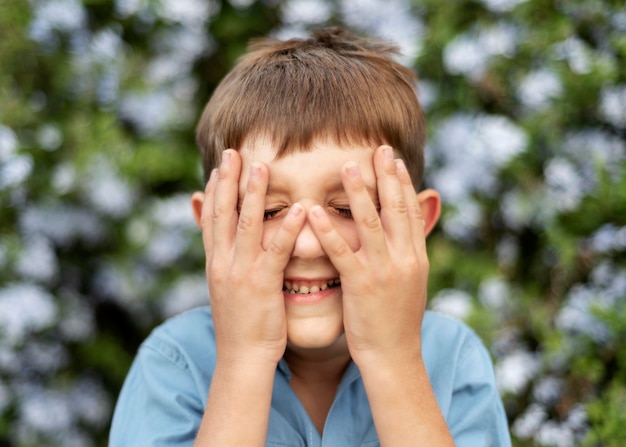 Free Photo close up kid covering his face