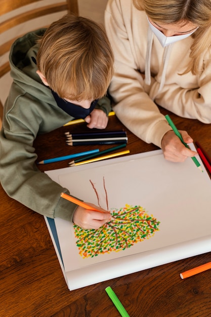 Close-up kid drawing indoors