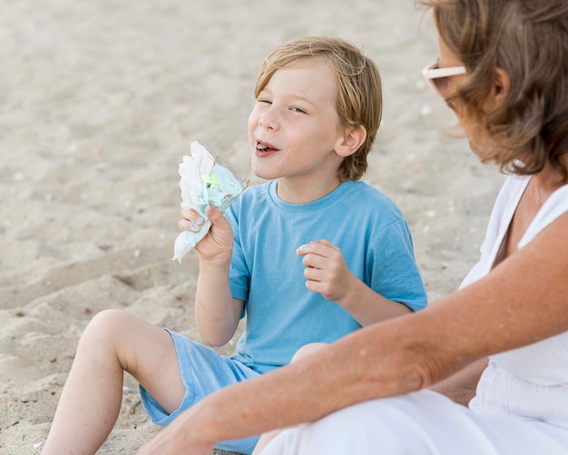 Close-up kid eating seeds on beach