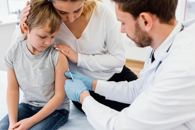 Free Photo close-up kid getting vaccinated