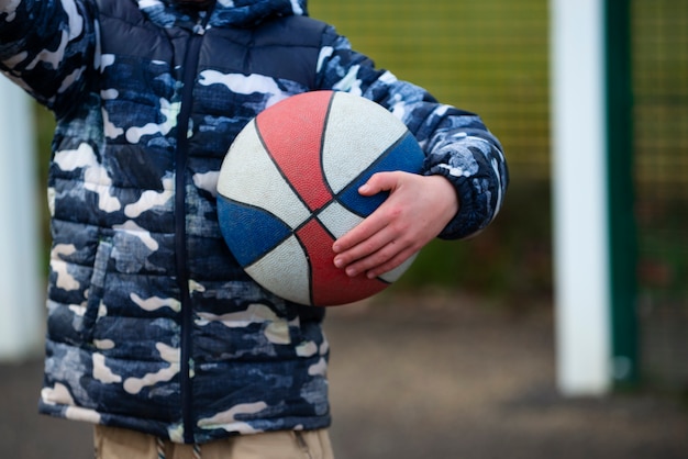 Close up kid holding ball