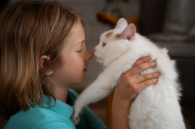 Close up kid holding cat