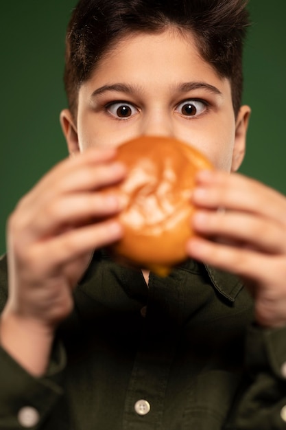 Free Photo close-up kid holding donut