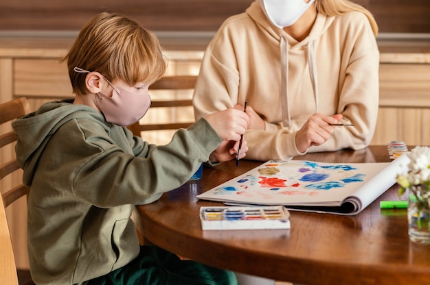 Close-up kid painting on paper