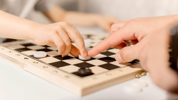 Close-up kid playing chess