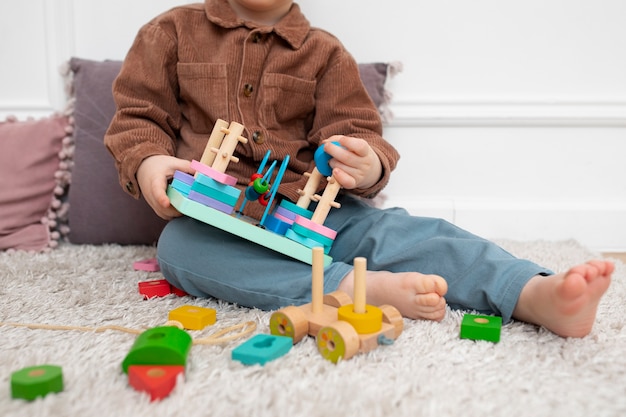 Free photo close up kid playing with educational toy