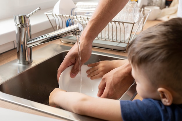 Free photo close up kid washing dish