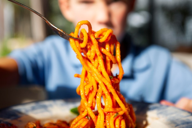 Close up kid with delicious spaghetti