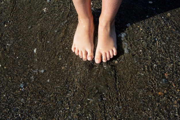 Free Photo close up kids feet on beach