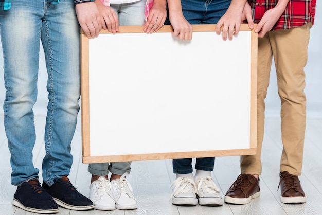 Close-up kids holding frame