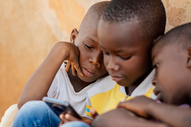 Close-up kids looking at smartphone