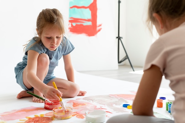 Close up kids painting together inside