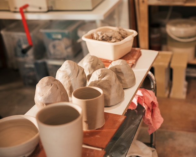 Close-up of kneaded dough; ceramic vase on table