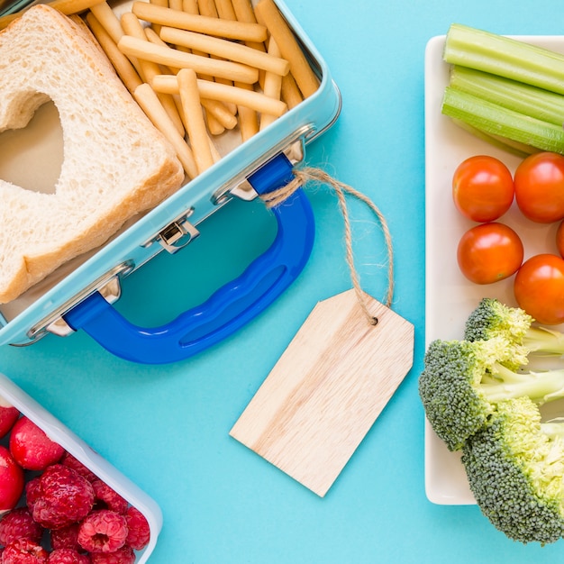 Close-up labelled lunchbox near food