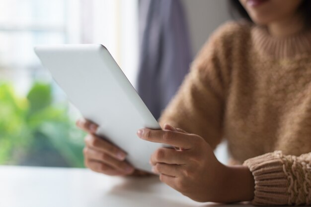 Close-up of lady using modern tablet