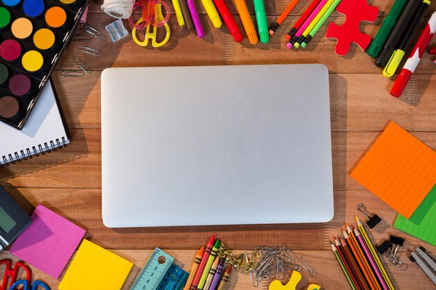 Close-up of laptop with various stationery